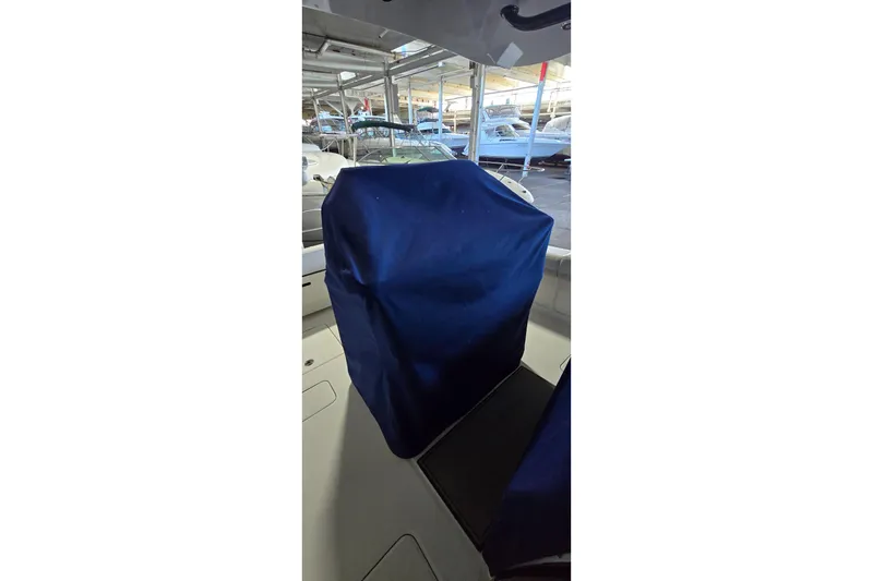 Slide: The Image of 2024 WorldCat 280 CC-X boat interior with blue cover, docked in a marina. - 38