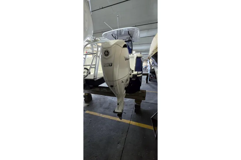 Slide: The Image of 2024 WorldCat 280 CC-X boat with Yamaha 200 outboard motor in storage. - 39