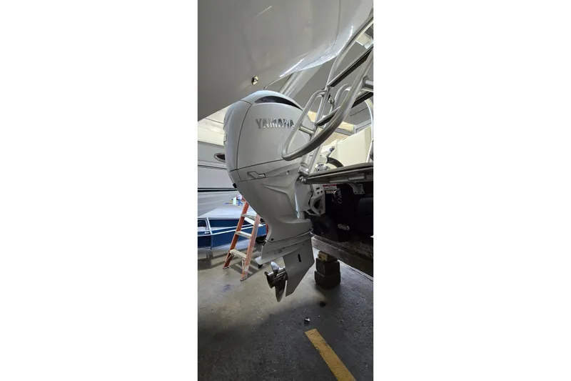Slide: The Image of 2024 WorldCat 280 CC-X boat with Yamaha outboard motor in a garage setting. - 41