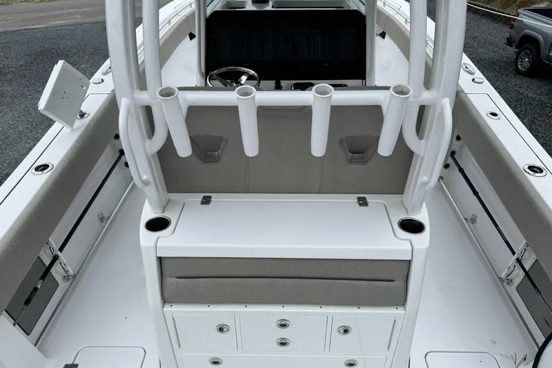 Slide: The Image of 2021 Sportsman Open 322 Center Console boat interior with rod holders and storage compartments. - 11