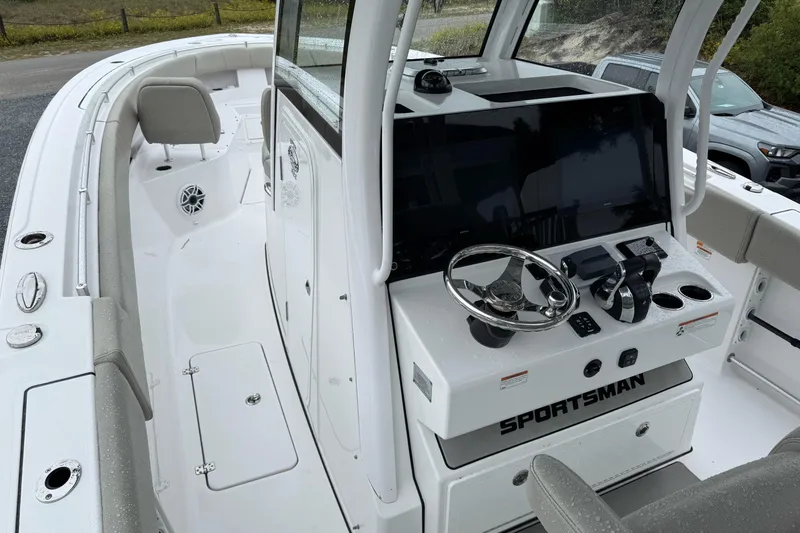 Slide: The Image of 2021 Sportsman Open 322 Center Console boat interior with steering wheel and controls. - 13
