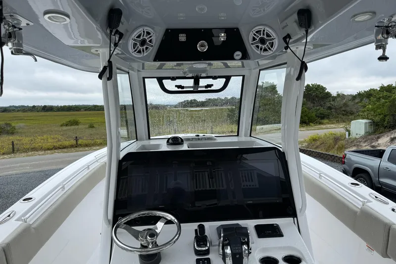 Slide: The Image of 2021 Sportsman Open 322 Center Console boat interior with steering wheel and control panel. - 14
