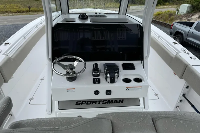 Slide: The Image of 2021 Sportsman Open 322 Center Console boat dashboard with steering wheel and controls. - 15