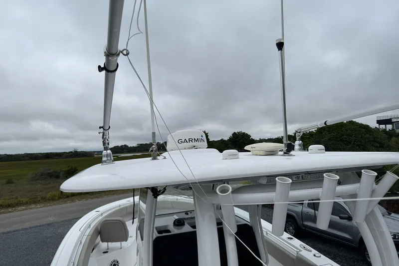 Slide: The Image of 2021 Sportsman Open 322 Center Console with Garmin equipment on a cloudy day. - 20