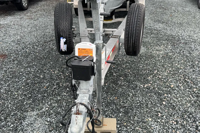 Slide: The Image of Trailer for 2021 Sportsman Open 322 Center Console on gravel surface. - 21