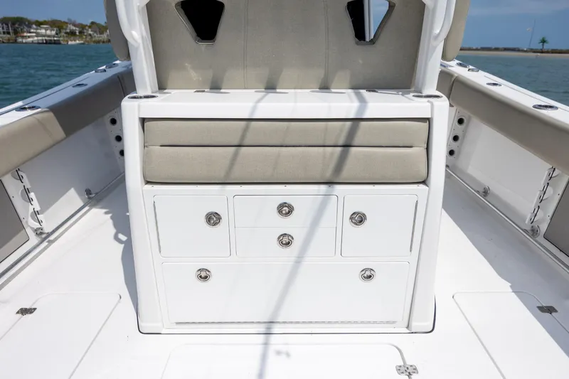 Slide: The Image of 2021 Sportsman Open 322 Center Console boat interior with storage drawers and cushioned seating. - 25