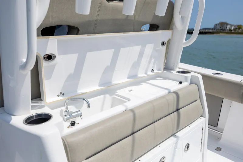 Slide: The Image of 2021 Sportsman Open 322 Center Console boat interior with sink and seating. - 26
