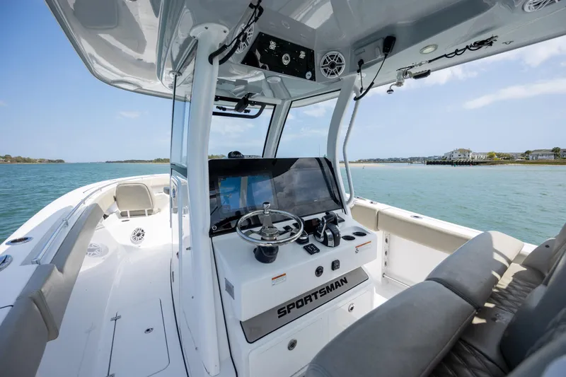 Slide: The Image of 2021 Sportsman Open 322 Center Console boat interior with steering wheel, on a sunny day. - 29