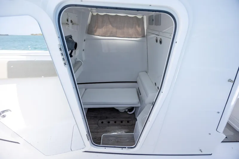 Slide: The Image of 2021 Sportsman Open 322 Center Console cabin interior with seating and storage. - 34