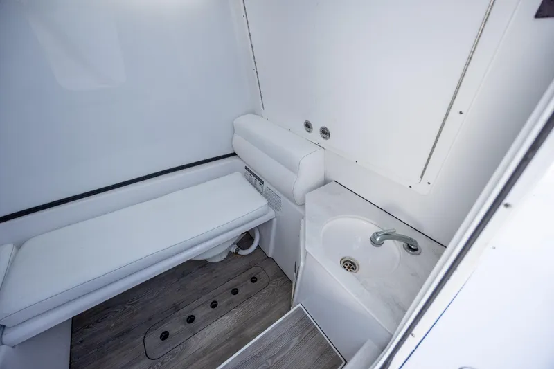 Slide: The Image of 2021 Sportsman Open 322 Center Console interior with sink and seating area. - 35