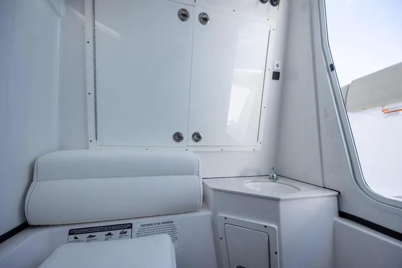 Slide: The Image of 2021 Sportsman Open 322 Center Console interior with seating and sink. - 36