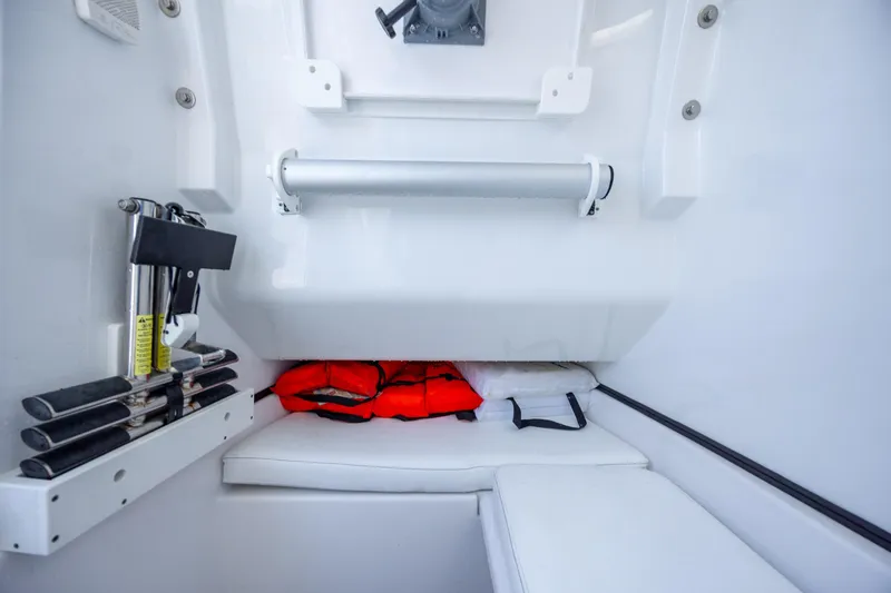 Slide: The Image of 2021 Sportsman Open 322 Center Console interior with life jackets and storage area. - 37