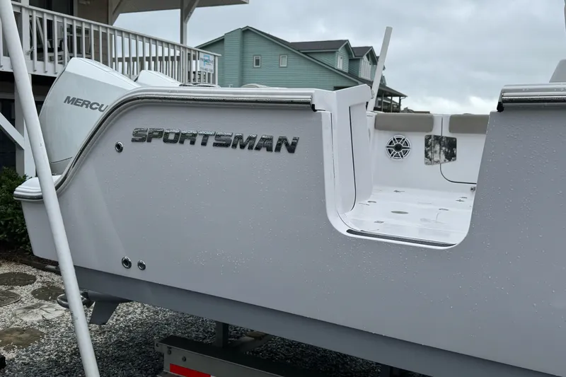 Slide: The Image of 2021 Sportsman Open 322 Center Console boat with Mercury engine, docked outdoors. - 4