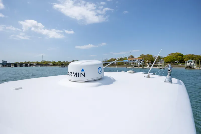 Slide: The Image of 2021 Sportsman Open 322 Center Console boat with Garmin radar on calm water. - 43