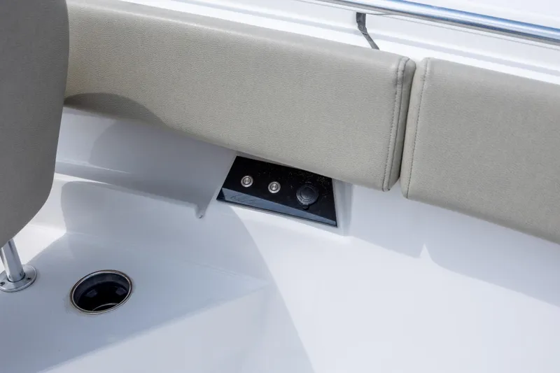 Slide: The Image of 2021 Sportsman Open 322 Center Console boat interior with cushioned seating and control panel. - 46