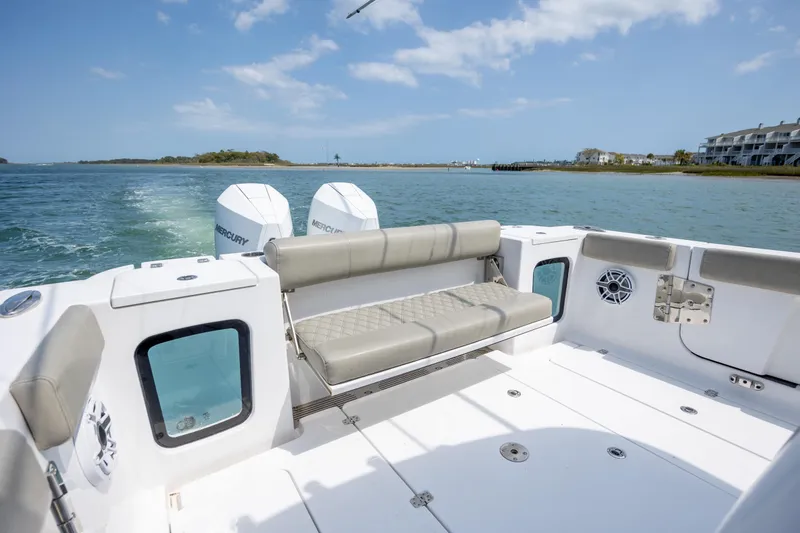 Slide: The Image of 2021 Sportsman Open 322 Center Console boat with dual Mercury engines on a sunny day. - 47