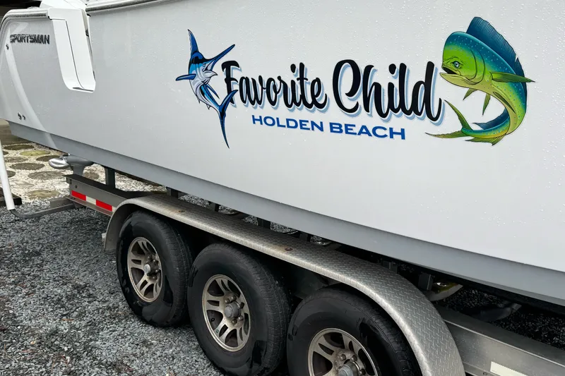 Slide: The Image of 2021 Sportsman Open 322 Center Console boat with "Favorite Child" decal at Holden Beach. - 5
