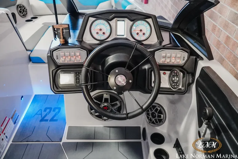 Slide: The Image of 2021 Axis A22 boat dashboard with steering wheel and control panel at Lake Norman Marina. - 12
