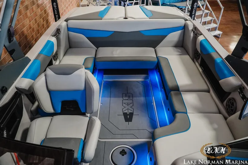 Slide: The Image of 2021 Axis A22 boat interior with blue LED lighting and gray seating at Lake Norman Marina. - 15