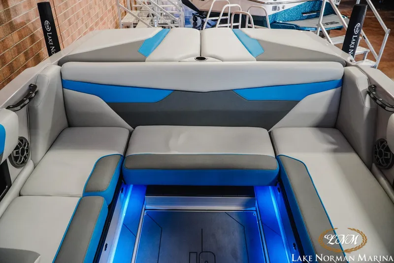 Slide: The Image of 2021 Axis A22 boat interior with blue LED lighting and gray-blue seating at Lake Norman Marina. - 16