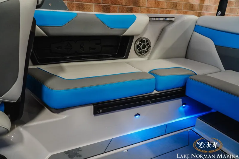 Slide: The Image of 2021 Axis A22 boat interior with blue and gray seating, speaker, and ambient lighting. - 17