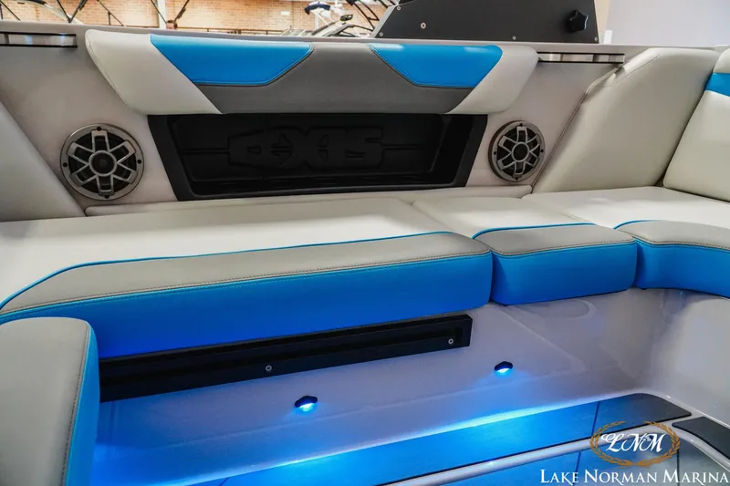 Slide: The Image of 2021 Axis A22 boat interior with blue LED lighting and stylish seating. - 18