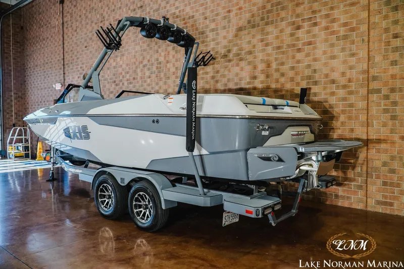 Slide: The Image of 2021 Axis A22 boat on trailer at Lake Norman Marina indoors. - 2