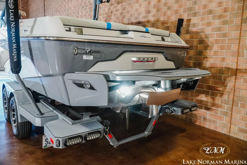 Slide: The Image of 2021 Axis A22 boat on trailer at Lake Norman Marina, showcasing rear design. - 6