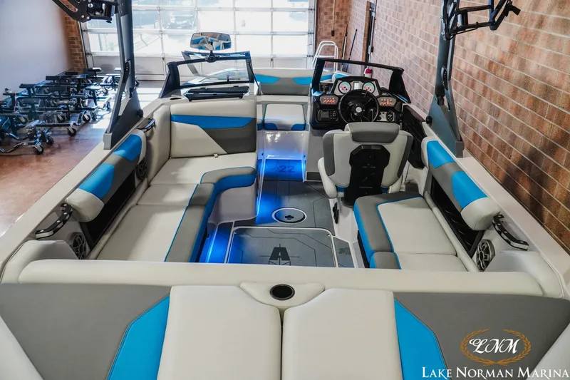 Slide: The Image of 2021 Axis A22 boat interior with blue and gray seating, showcased at Lake Norman Marina. - 8