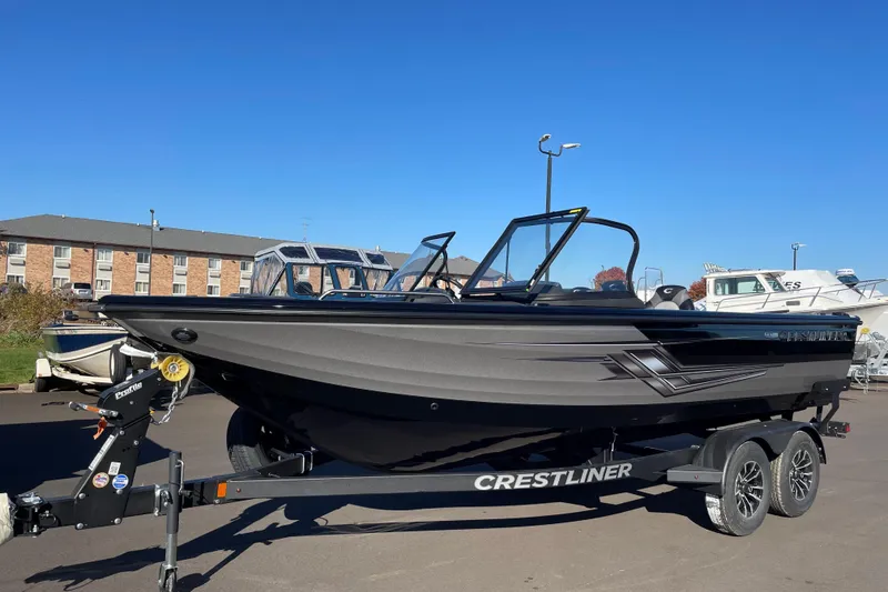 The Image of 2026 Crestliner 2050 Authority boat on trailer under clear blue sky. - 0