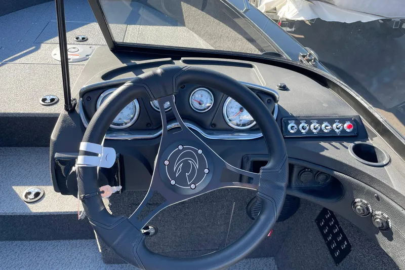 Slide: The Image of Steering wheel and dashboard of 2026 Crestliner 2050 Authority boat, featuring gauges and controls. - 14