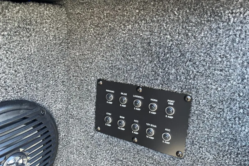 Slide: The Image of Control panel on 2026 Crestliner 2050 Authority boat with labeled switches and speaker. - 16