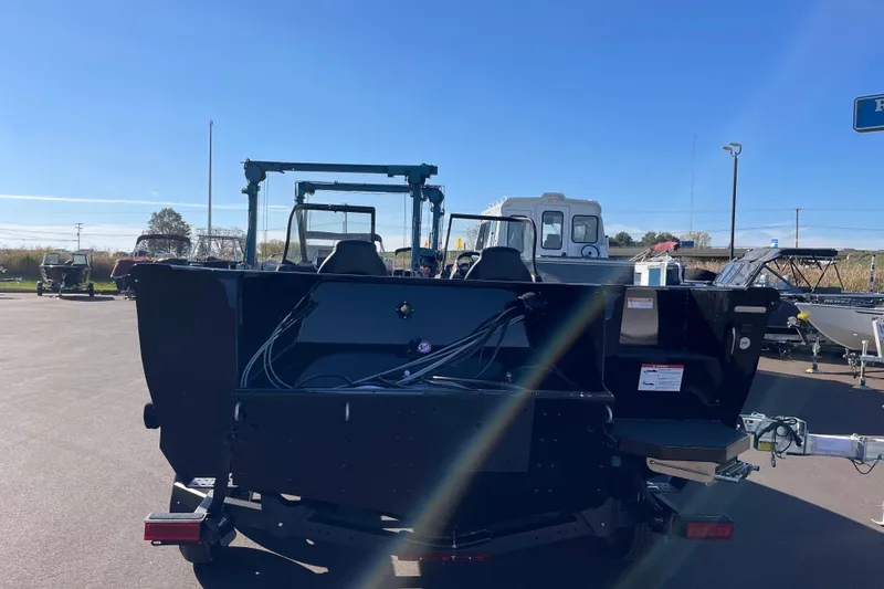 Slide: The Image of 2026 Crestliner 2050 Authority boat, rear view in a sunny outdoor setting. - 2