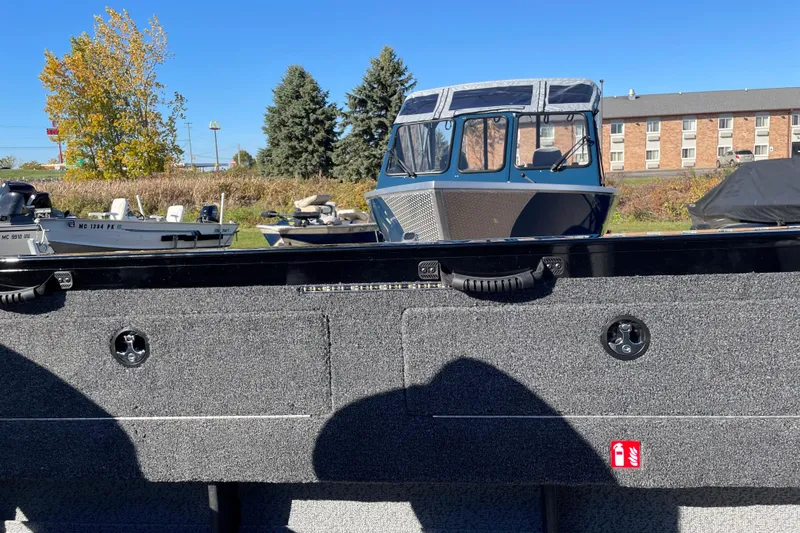 Slide: The Image of 2026 Crestliner 2050 Authority boat in outdoor setting, surrounded by trees and buildings. - 6