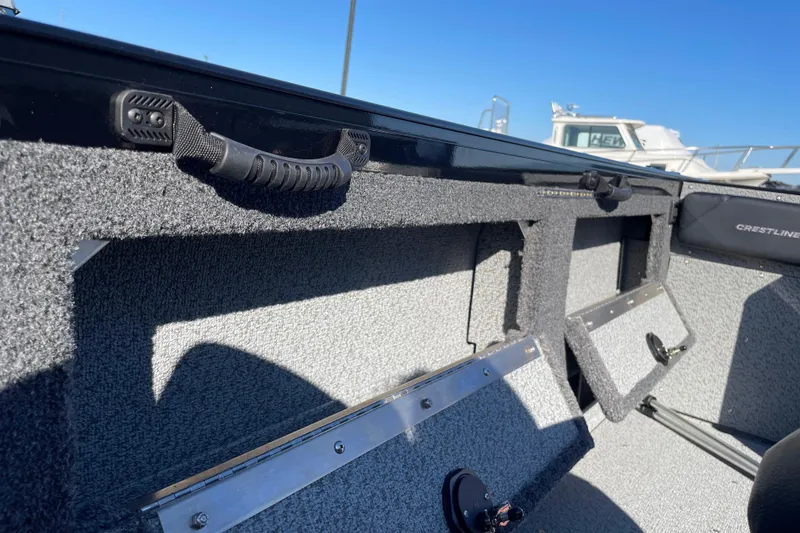 Slide: The Image of 2026 Crestliner 2050 Authority boat interior with storage compartments and handle grips. - 7