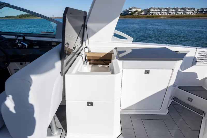 Slide: The Image of 2023 Aviara AV32 OB boat interior with sleek kitchenette and water view. - 20