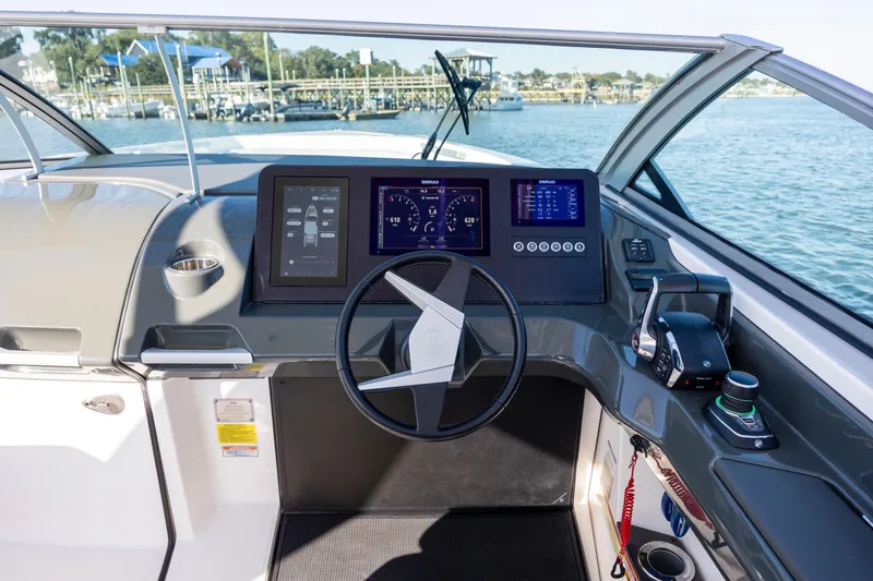 Slide: The Image of Helm of 2023 Aviara AV32 OB boat with modern controls and digital displays. - 22