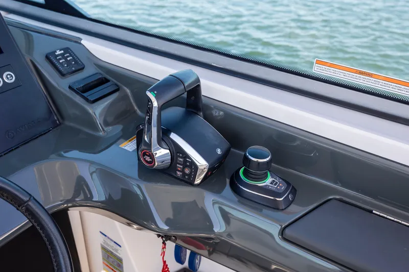 Slide: The Image of 2023 Aviara AV32 OB boat controls with joystick and throttle on dashboard. - 23
