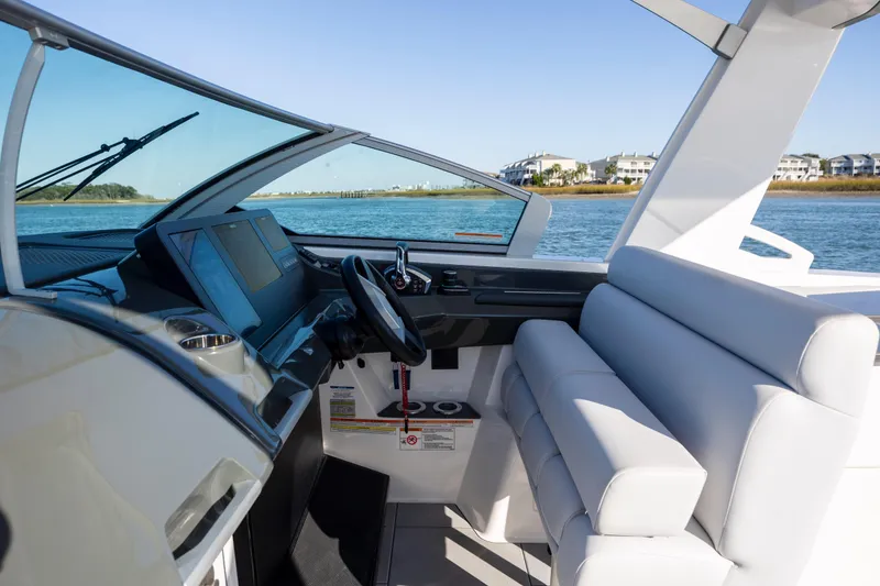 Slide: The Image of 2023 Aviara AV32 OB boat interior with modern dashboard and comfortable seating. - 24