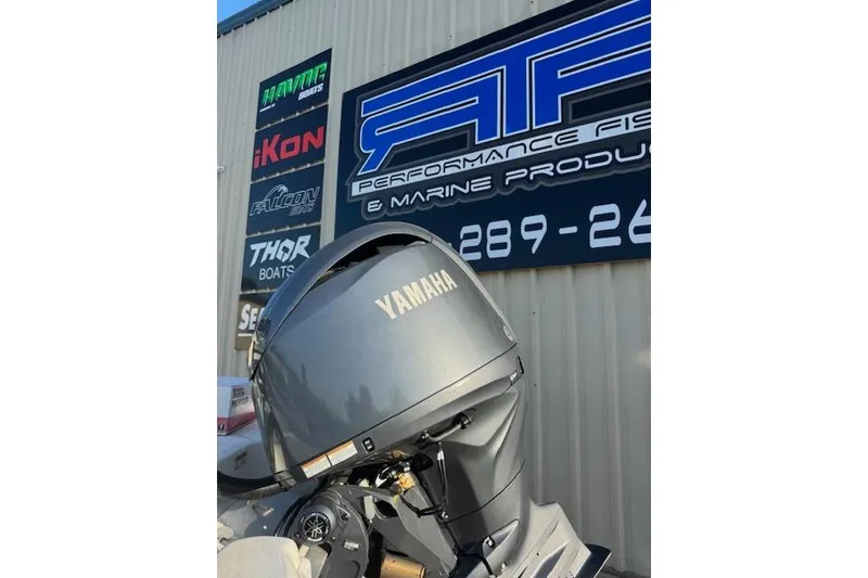 Slide: The Image of 2025 NauticStar 214 Bay with Yamaha engine at marine dealership. - 2