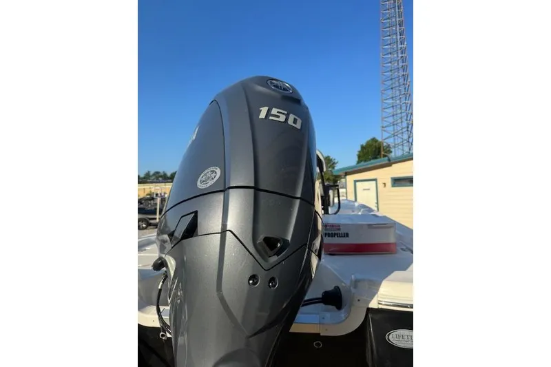 Slide: The Image of 2025 NauticStar 214 Bay boat with a 150 horsepower outboard motor. - 3