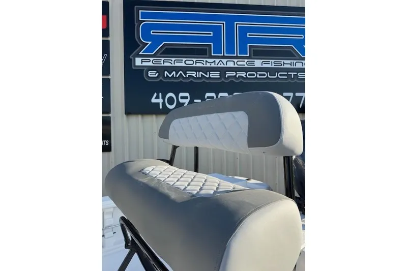 Slide: The Image of 2025 NauticStar 214 Bay boat seat with quilted design, displayed at marine products store. - 5