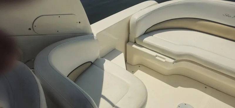 Slide: The Image of 2008 Sea Ray 260 Sundancer boat interior with white cushioned seating. - 10