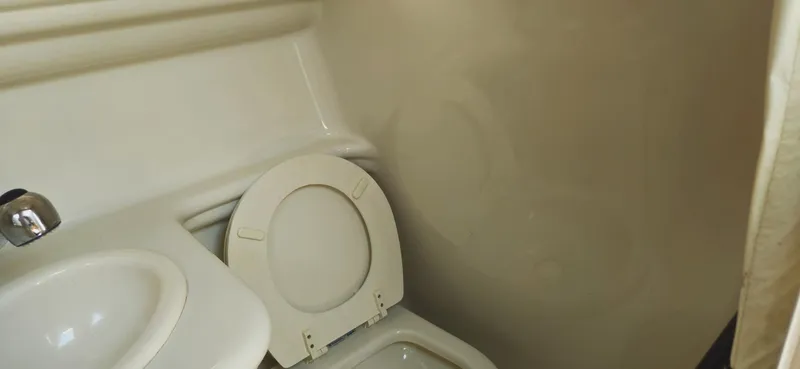 Slide: The Image of 2008 Sea Ray 260 Sundancer bathroom with toilet and sink. - 29