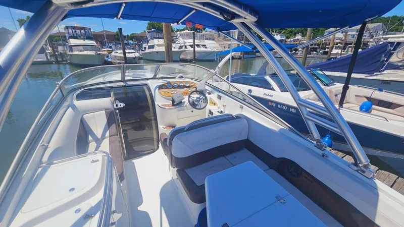 Slide: The Image of 1999 Cobalt 293 boat interior with blue canopy, docked at marina. - 8