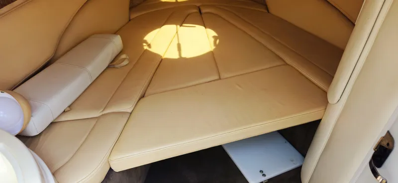 Slide: The Image of Interior cabin of a 1999 Cobalt 293 boat with beige leather seating. - 12