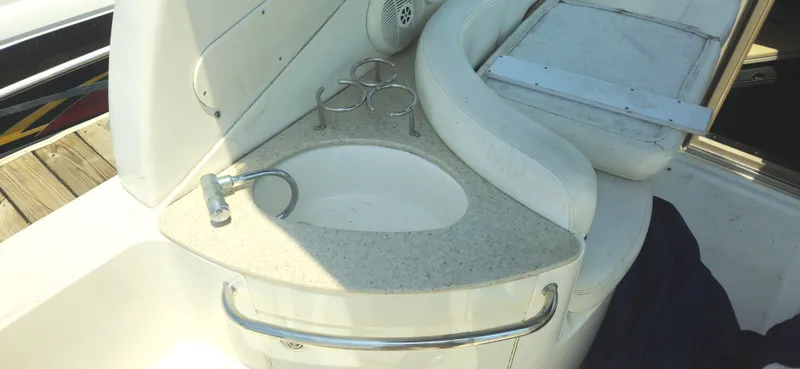 Slide: The Image of 1999 Cobalt 293 boat interior with sink and cup holders. - 7