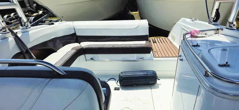 Slide: The Image of Interior of a 1999 Cobalt 293 boat with white seating and wooden deck. - 9
