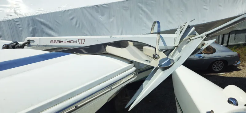 Slide: The Image of 1999 Cobalt 293 boat with a Fortress anchor, parked outdoors. - 10