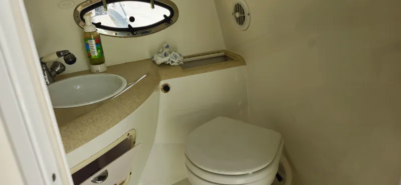 Slide: The Image of Interior of a 1999 Cobalt 293 boat bathroom with sink and toilet. - 16
